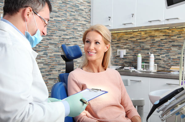 Woman talking to dentist during dental exam, at Cleary Dental in Haddonfield, NJ.