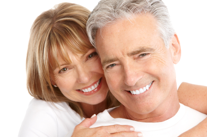 Mature couple smiling with dental implants at Cleary Dental in Haddonfield, NJ.