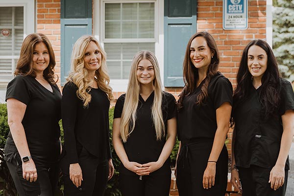 Image of all the hygienists standing together in front of Cleary Dental office building.