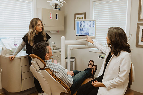 Patient reviewing a digital x-ray with Dr. Courtney Cleary.